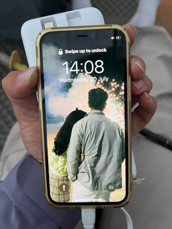 丘盈盈さんと夫の後ろ姿が壁紙になっている丘さんのスマホ。(写真は取材対象者が提供)